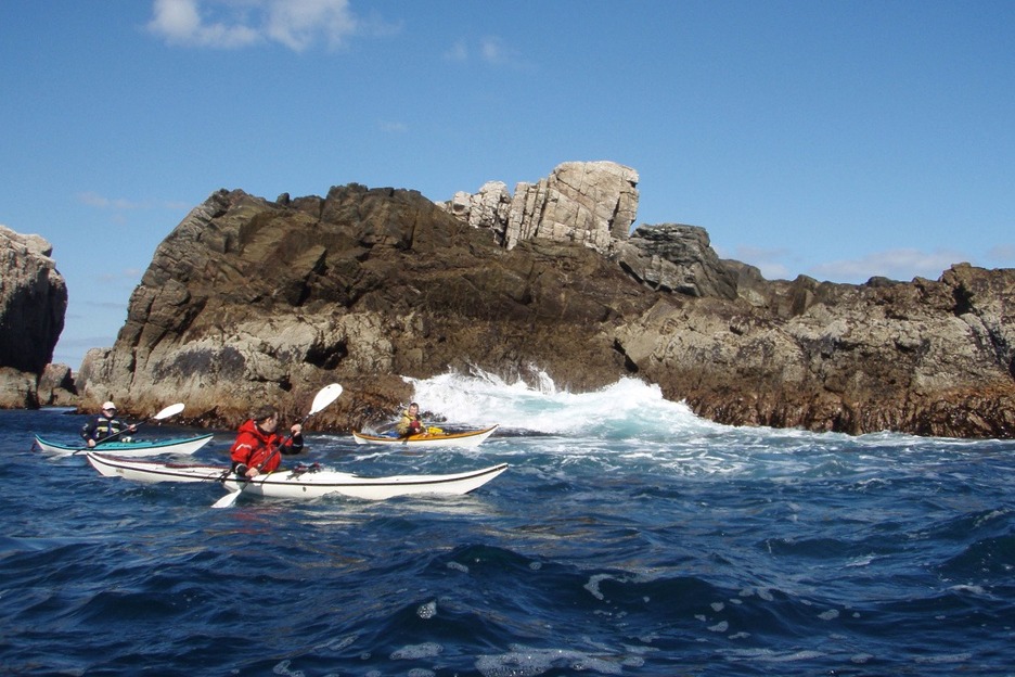 Three sea kayakers in Scotland